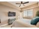 Comfortable bedroom featuring a ceiling fan, and a flat screen TV at 63 E Agate Ave # 509, Las Vegas, NV 89123
