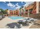 Relaxing community pool area with lounge chairs and manicured landscaping at 63 E Agate Ave # 509, Las Vegas, NV 89123
