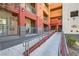 Apartment complex featuring access ramps, private balconies, multiple stories, colorful accents, and secure access points at 63 E Agate Ave # 509, Las Vegas, NV 89123
