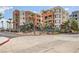 Contemporary condo building featuring multiple floors, colorful accents, landscaping, and convenient parking access at 63 E Agate Ave # 509, Las Vegas, NV 89123