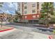 Apartment building showcasing multi-story architecture, private parking entrances, landscaping, and a well-maintained exterior at 63 E Agate Ave # 509, Las Vegas, NV 89123