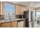 Bright kitchen with stainless steel appliances, granite counters, and light wood cabinets at 63 E Agate Ave # 509, Las Vegas, NV 89123