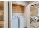 Convenient laundry closet featuring a washer, dryer, and built-in storage cabinets at 63 E Agate Ave # 509, Las Vegas, NV 89123
