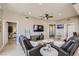 Comfortable living room featuring reclining leather sofa, ceiling fan, and wall mounted TV at 63 E Agate Ave # 509, Las Vegas, NV 89123