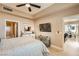 Main bedroom with ceiling fan, flat-screen TV, and ensuite bathroom at 63 E Agate Ave # 509, Las Vegas, NV 89123