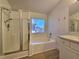 Bathroom featuring a separate shower, soaking tub, and a window with neighborhood views at 6638 Babys Tear Pl, Las Vegas, NV 89148