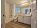 Bathroom featuring a tub-shower combo, modern toilet and vanity with marble countertops at 6638 Babys Tear Pl, Las Vegas, NV 89148