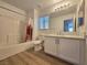 Bright bathroom featuring a tub-shower combo, vanity with marble top and modern fixtures at 6638 Babys Tear Pl, Las Vegas, NV 89148