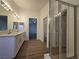 Bathroom with double vanity, shower, toilet room, and light wood-look floors at 6638 Babys Tear Pl, Las Vegas, NV 89148