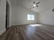 Large bedroom featuring modern flooring, natural light, and a ceiling fan at 6638 Babys Tear Pl, Las Vegas, NV 89148
