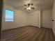 This bedroom has a window providing ample light and wood laminate flooring at 6638 Babys Tear Pl, Las Vegas, NV 89148