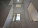 High ceiling entryway with decorative glass front door and sidelight window at 6638 Babys Tear Pl, Las Vegas, NV 89148