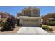 Inviting two-story home featuring a well-manicured yard and neutral color palette at 6638 Babys Tear Pl, Las Vegas, NV 89148