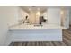 Open concept kitchen with breakfast bar and stainless steel sink at 6638 Babys Tear Pl, Las Vegas, NV 89148