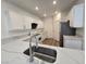 Bright kitchen features white cabinetry, stainless steel appliances, and marble countertops at 6638 Babys Tear Pl, Las Vegas, NV 89148