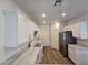 Modern kitchen with quartz countertops, white cabinets, and stainless steel appliances at 6638 Babys Tear Pl, Las Vegas, NV 89148