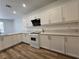 Updated kitchen with white cabinets, quartz countertops, and modern appliances at 6638 Babys Tear Pl, Las Vegas, NV 89148