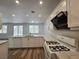 Bright kitchen featuring white cabinets, quartz countertops and stainless appliances at 6638 Babys Tear Pl, Las Vegas, NV 89148