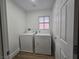 Laundry room featuring a washer, dryer, and a window for natural light at 6638 Babys Tear Pl, Las Vegas, NV 89148