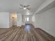 Bright living room with ceiling fan, wood-look floors and neutral paint at 6638 Babys Tear Pl, Las Vegas, NV 89148