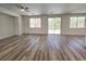 Open concept living area with wood-look flooring and sliding glass doors at 6638 Babys Tear Pl, Las Vegas, NV 89148