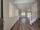 Spacious living room with wood-look flooring and ample natural light at 6638 Babys Tear Pl, Las Vegas, NV 89148