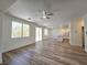 Open-concept living area featuring wood-look flooring and bright, neutral paint at 6638 Babys Tear Pl, Las Vegas, NV 89148