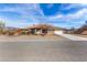 Charming single-story home with desert landscaping and a spacious driveway leading to a two-car garage at 6781 Southgate St, Pahrump, NV 89061