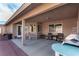 Covered patio perfect for outdoor gatherings, featuring a BBQ and comfortable seating at 6781 Southgate St, Pahrump, NV 89061