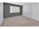 Bedroom with neutral carpet and white shuttered window at 690 Ambling Gait Ave, Henderson, NV 89015