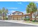 Charming home featuring an attached garage, well-maintained landscaping and mature trees at 690 Ambling Gait Ave, Henderson, NV 89015