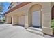 Home with garage and entryway, featuring a secure screen door and stucco walls at 690 Ambling Gait Ave, Henderson, NV 89015