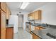 Well-lit kitchen with granite counters, stainless appliances, and tile flooring at 690 Ambling Gait Ave, Henderson, NV 89015