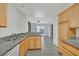 Bright kitchen with stainless steel sink, granite countertops, and views of the living area at 690 Ambling Gait Ave, Henderson, NV 89015