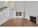 Open floor plan with new flooring, fireplace, built-in shelves, and view to kitchen at 690 Ambling Gait Ave, Henderson, NV 89015