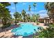 Community pool area surrounded by various palm trees and foliage at 690 Ambling Gait Ave, Henderson, NV 89015