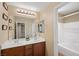 Well-lit bathroom with double sinks, a large mirror, and a separate toilet/shower area at 7028 Weavers Pl, North Las Vegas, NV 89084