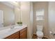The bathroom has a vanity, large mirror, and toilet with a window to allow for natural light at 7028 Weavers Pl, North Las Vegas, NV 89084