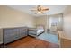 Inviting bedroom with hardwood floors, ample natural light, and a calming color scheme at 7028 Weavers Pl, North Las Vegas, NV 89084