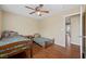 Bright bedroom with hardwood floors, ceiling fan, and a view from the doorway into the rest of the home at 7028 Weavers Pl, North Las Vegas, NV 89084
