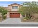 Beautiful two-story home featuring a well-maintained lawn, mature trees, and a two car garage at 7028 Weavers Pl, North Las Vegas, NV 89084