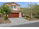 Charming two-story home featuring a large two car garage and a well-maintained landscaped front yard at 7028 Weavers Pl, North Las Vegas, NV 89084