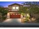 Inviting two-story home featuring a well-maintained yard and a two-car garage, perfect for a Gathering at 7028 Weavers Pl, North Las Vegas, NV 89084
