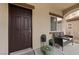 Inviting front porch with seating and potted plants, creating a welcoming entrance at 7028 Weavers Pl, North Las Vegas, NV 89084