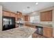 Beautiful kitchen featuring wood cabinets, stainless steel appliances and granite countertops at 7028 Weavers Pl, North Las Vegas, NV 89084