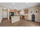 Modern kitchen featuring wood cabinets, stainless steel appliances, and granite countertops at 7028 Weavers Pl, North Las Vegas, NV 89084