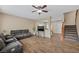 Cozy living room with hardwood floors, ceiling fan, and comfortable seating arrangement at 7028 Weavers Pl, North Las Vegas, NV 89084