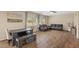 Inviting living area with wood floors, modern furniture and a view into the dining space at 7028 Weavers Pl, North Las Vegas, NV 89084