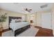 Spacious main bedroom with hardwood floors, ceiling fan, and access to the ensuite bathroom at 7028 Weavers Pl, North Las Vegas, NV 89084