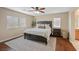Relaxing main bedroom with hardwood floors, ceiling fan, and large windows for ample sunlight at 7028 Weavers Pl, North Las Vegas, NV 89084